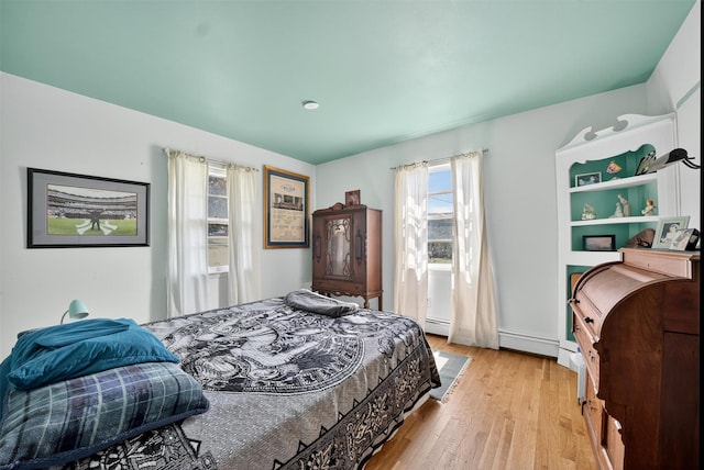 57 Panorama Dr, Patterson, NY 12563 - bedroom featuring light wood-style floors and a baseboard heating unit
