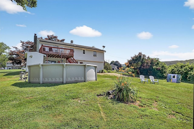 57 Panorama Dr, Patterson, NY 12563 - rear view of house with a deck, a yard, and a garage