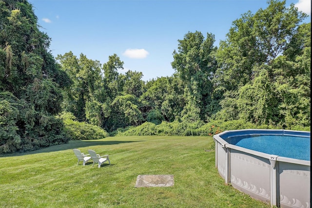 57 Panorama Dr, Patterson, NY 12563 - swimming pool featuring a lawn and a forest view