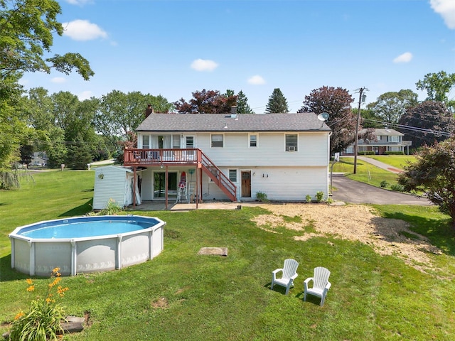 57 Panorama Dr, Patterson, NY 12563 - rear view of property featuring stairs, a deck, a yard, an outdoor pool, and a chimney