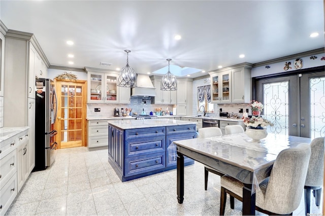 338 Cold Spring Rd, Syosset, NY 11791 - kitchen featuring stainless steel appliances, blue cabinetry, custom range hood, ornamental molding, and a sink