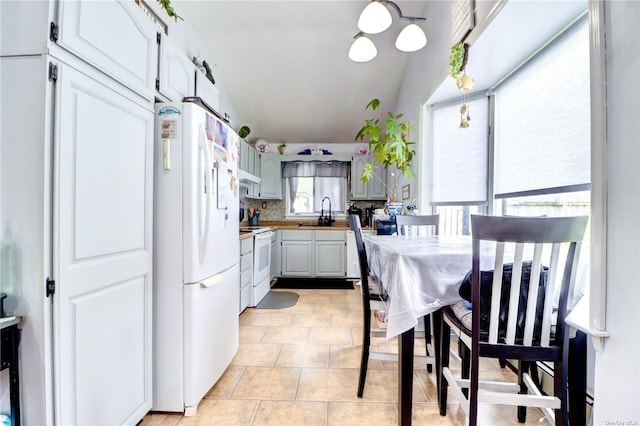 338 Cold Spring Rd, Syosset, NY 11791 - kitchen with white appliances, backsplash, under cabinet range hood, and light countertops