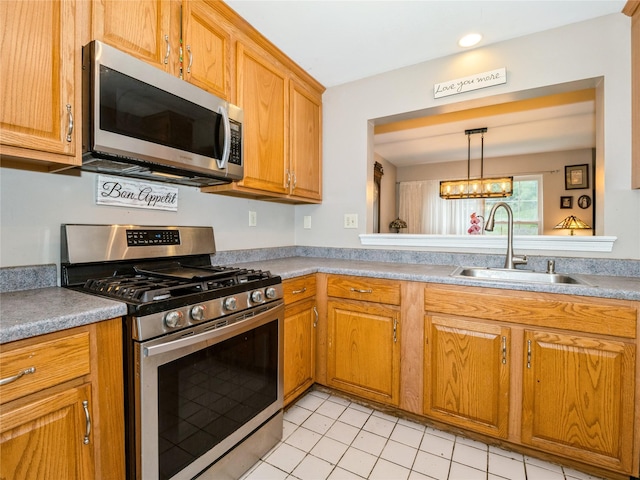 47 Muirfield Ct, Poughkeepsie, NY 12603 - kitchen featuring stainless steel appliances, a sink, light tile patterned floors, brown cabinets, and light countertops