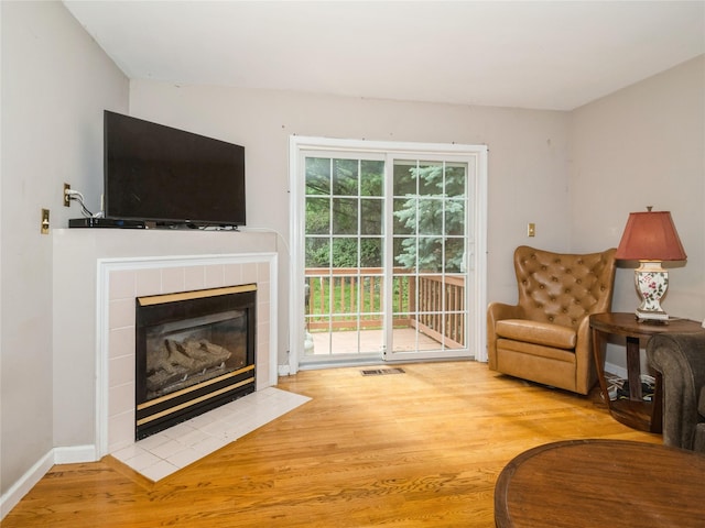 47 Muirfield Ct, Poughkeepsie, NY 12603 - living room featuring wood finished floors and a tiled fireplace