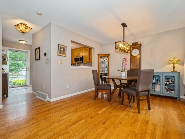 47 Muirfield Ct, Poughkeepsie, NY 12603 - dining space with light wood finished floors and a chandelier