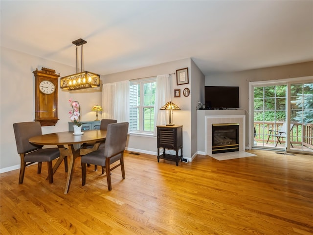 47 Muirfield Ct, Poughkeepsie, NY 12603 - dining room with light wood-style floors and a tile fireplace