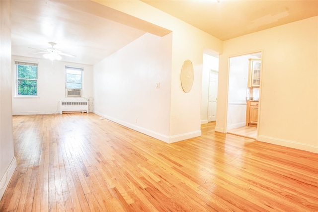 1 Georgia Ave Unit 5A, Bronxville, NY 10708 - unfurnished room featuring radiator heating unit, light wood-style flooring, a ceiling fan, and baseboards