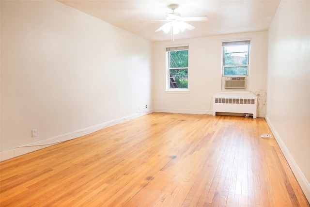 1 Georgia Ave Unit 5A, Bronxville, NY 10708 - spare room with radiator, light wood-type flooring, ceiling fan, baseboards, and cooling unit