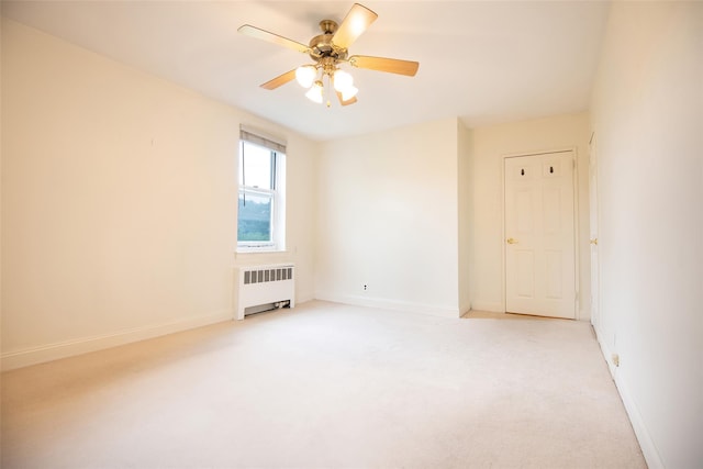 1 Georgia Ave Unit 5A, Bronxville, NY 10708 - spare room featuring radiator heating unit, light carpet, baseboards, and a ceiling fan