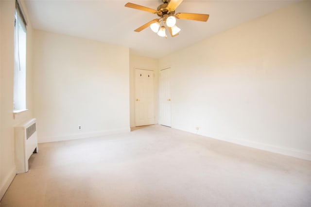 1 Georgia Ave Unit 5A, Bronxville, NY 10708 - spare room with radiator heating unit, light carpet, healthy amount of natural light, and baseboards