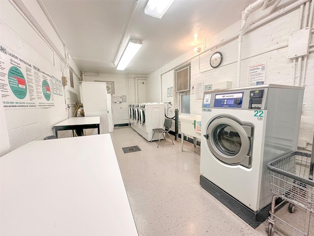 1 Georgia Ave Unit 5A, Bronxville, NY 10708 - shared laundry room with washer and clothes dryer and light flooring