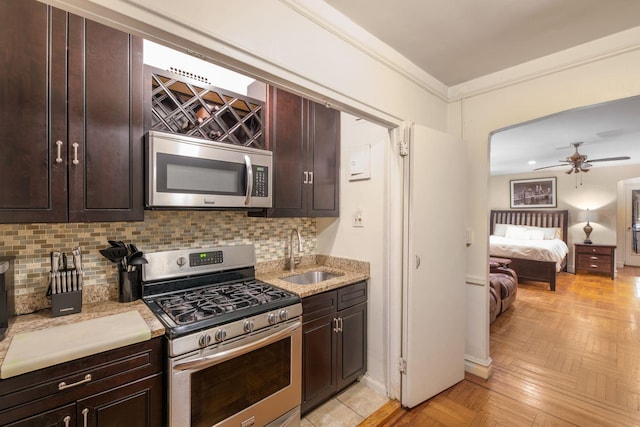 860 Grand Concourse Unit 4J, Bronx, NY 10451 - kitchen featuring appliances with stainless steel finishes, a sink, tasteful backsplash, crown molding, and a ceiling fan