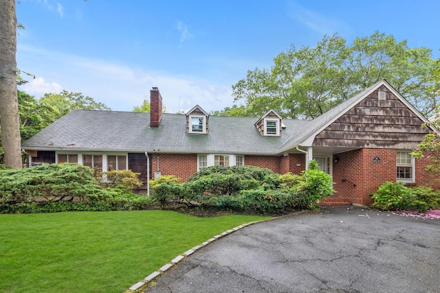 301 Margaret Blvd, Merrick, NY 11566 - cape cod-style house featuring a front lawn, a chimney, and brick siding