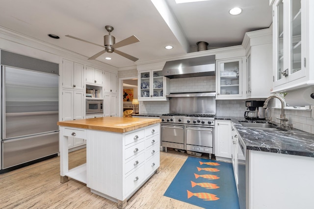 301 Margaret Blvd, Merrick, NY 11566 - kitchen with built in appliances, wooden counters, ceiling fan, white cabinetry, and recessed lighting