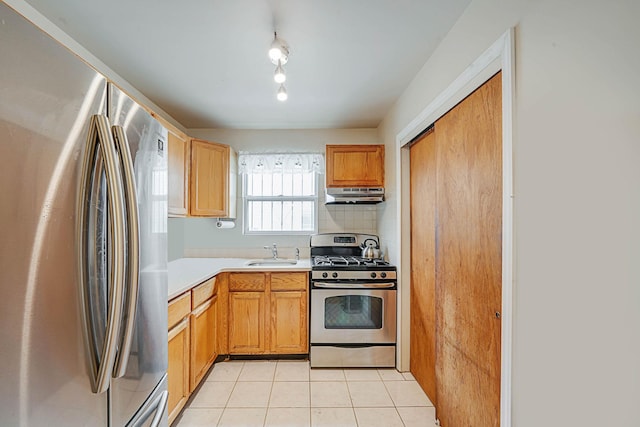 14015 159th St, Jamaica, NY 11434 - kitchen with appliances with stainless steel finishes, under cabinet range hood, a sink, light countertops, and light tile patterned floors