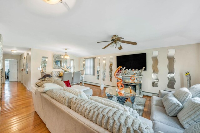 14015 159th St, Jamaica, NY 11434 - living room featuring a baseboard radiator, ceiling fan, healthy amount of natural light, and light wood-style floors