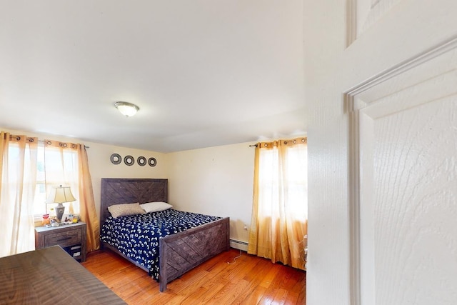 14015 159th St, Jamaica, NY 11434 - bedroom with light wood-style flooring and baseboard heating