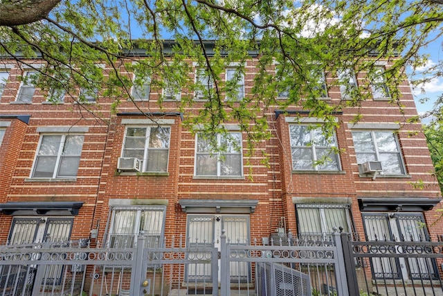 1830 Sterling Pl, Brooklyn, NY 11233 - townhome / multi-family property featuring brick siding, a gate, a fenced front yard, and cooling unit