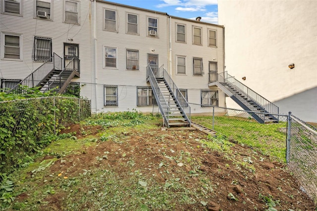 1830 Sterling Pl, Brooklyn, NY 11233 - view of building exterior featuring stairs, a fenced backyard, and cooling unit