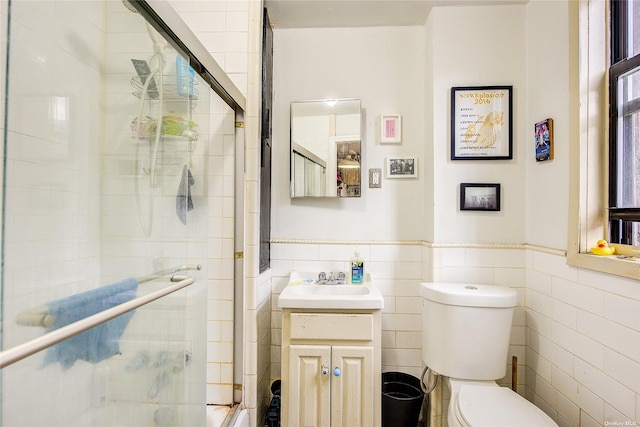 230 S 2nd St, Brooklyn, NY 11211 - full bathroom with tile walls, a stall shower, vanity, toilet, and wainscoting