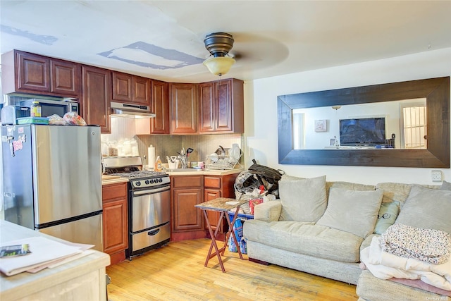 230 S 2nd St, Brooklyn, NY 11211 - kitchen featuring appliances with stainless steel finishes, open floor plan, under cabinet range hood, ceiling fan, and backsplash