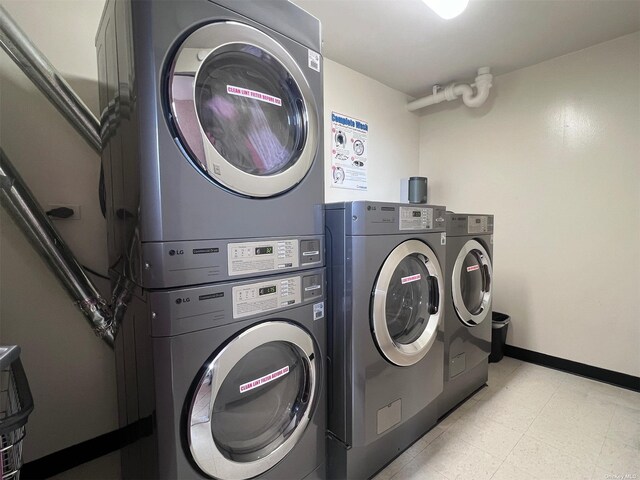 150-38 Union Tpke Unit 11G, Flushing, NY 11367 - laundry area featuring stacked washer and clothes dryer, light flooring, independent washer and dryer, and baseboards