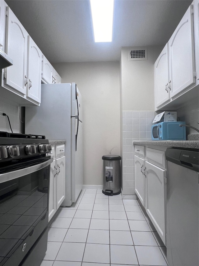 150-38 Union Tpke Unit 11G, Flushing, NY 11367 - kitchen with stainless steel appliances, white cabinetry, light tile patterned floors, and light countertops