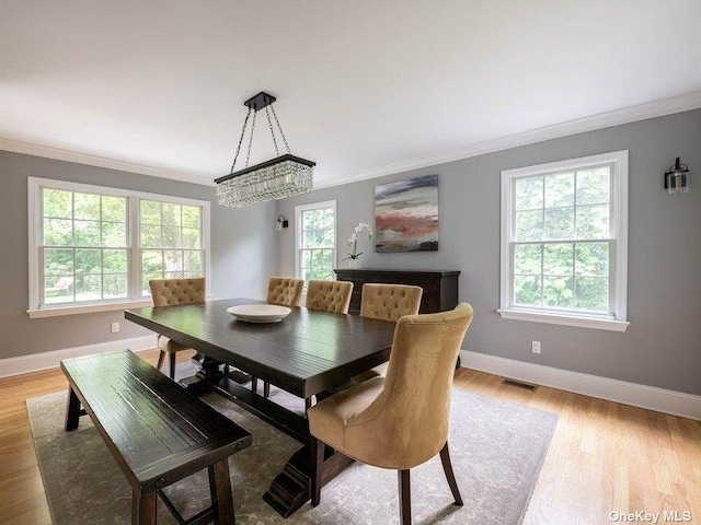 22 Homer Pl, Manhasset, NY 11030 - dining space featuring ornamental molding, baseboards, light wood-style floors, and a chandelier