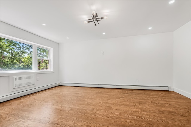 567 E 80th St, Brooklyn, NY 11236 - spare room featuring recessed lighting, wood finished floors, a wall mounted AC, and baseboards