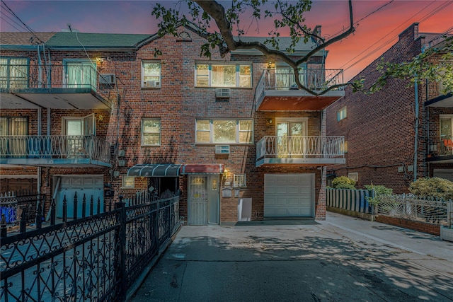 567 E 80th St, Brooklyn, NY 11236 - view of front of home featuring brick siding, concrete driveway, an attached garage, and a balcony