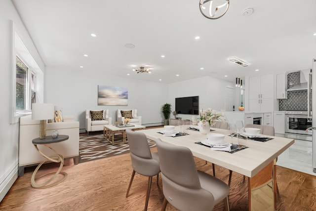 567 E 80th St, Brooklyn, NY 11236 - dining area featuring wood finished floors, recessed lighting, baseboard heating, and baseboards