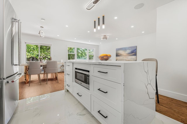 567 E 80th St, Brooklyn, NY 11236 - kitchen with appliances with stainless steel finishes, light stone countertops, white cabinetry, recessed lighting, and pendant lighting
