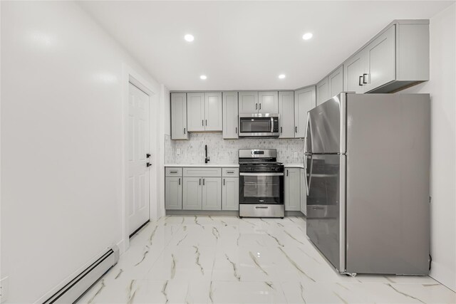 567 E 80th St, Brooklyn, NY 11236 - kitchen with appliances with stainless steel finishes, gray cabinetry, a baseboard heating unit, light marble finish floors, and recessed lighting