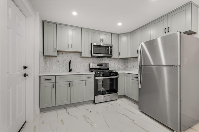 567 E 80th St, Brooklyn, NY 11236 - kitchen featuring stainless steel appliances, gray cabinetry, a sink, light marble finish floors, and recessed lighting