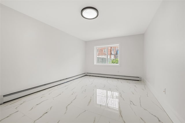 567 E 80th St, Brooklyn, NY 11236 - spare room featuring marble look tiles, a baseboard radiator, and baseboards