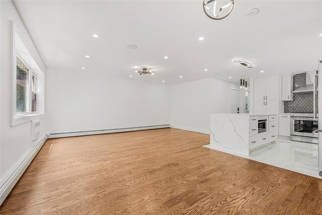567 E 80th St, Brooklyn, NY 11236 - unfurnished living room with a baseboard heating unit, a baseboard radiator, light wood-type flooring, recessed lighting, and baseboards