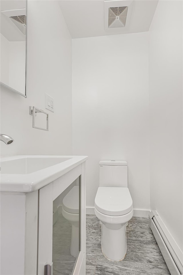 567 E 80th St, Brooklyn, NY 11236 - bathroom with a baseboard radiator, toilet, and baseboards