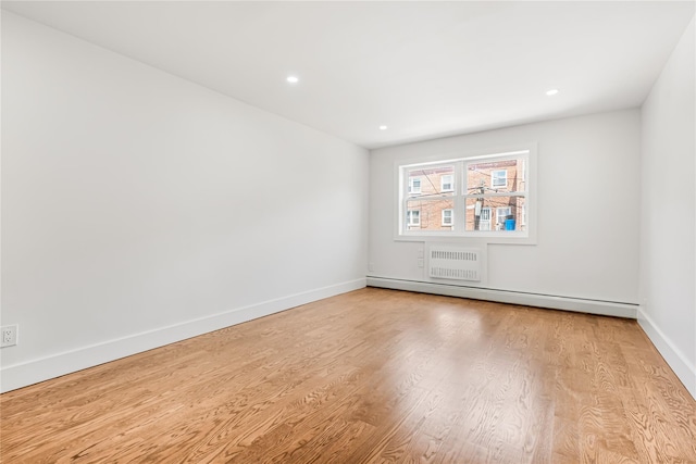 567 E 80th St, Brooklyn, NY 11236 - empty room with baseboard heating, wood finished floors, radiator heating unit, recessed lighting, and baseboards
