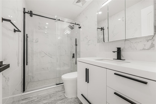 567 E 80th St, Brooklyn, NY 11236 - bathroom featuring vanity, a marble finish shower, toilet, marble finish floors, and tile walls