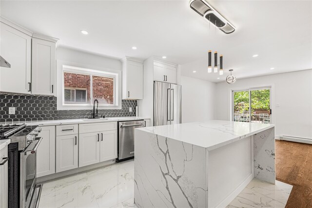 567 E 80th St, Brooklyn, NY 11236 - kitchen with high quality appliances, a kitchen island, a sink, decorative backsplash, and recessed lighting