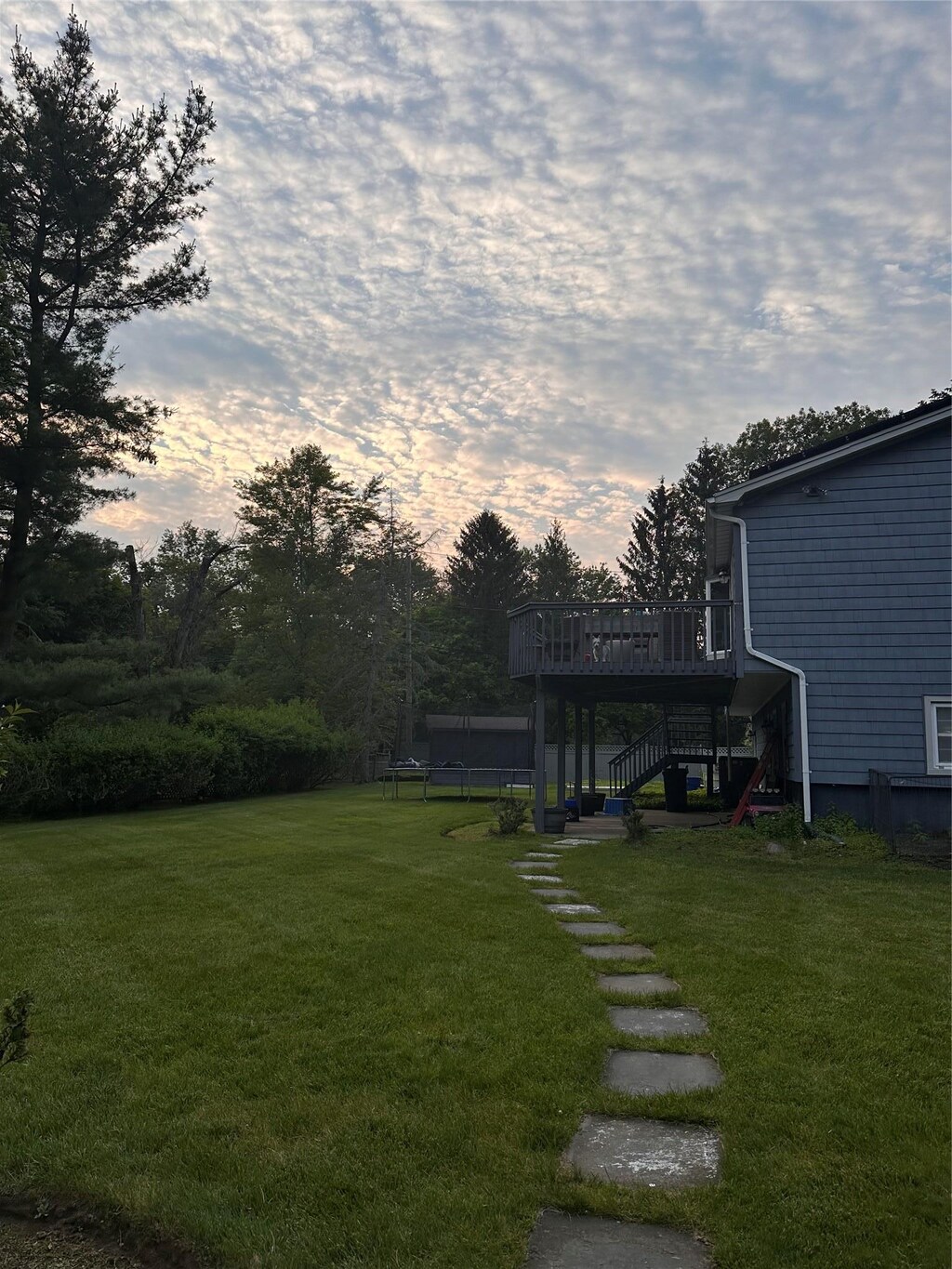 43 N Lorna Ln, Airmont, NY 10901 - view of grassy yard featuring a trampoline, stairs, and a deck