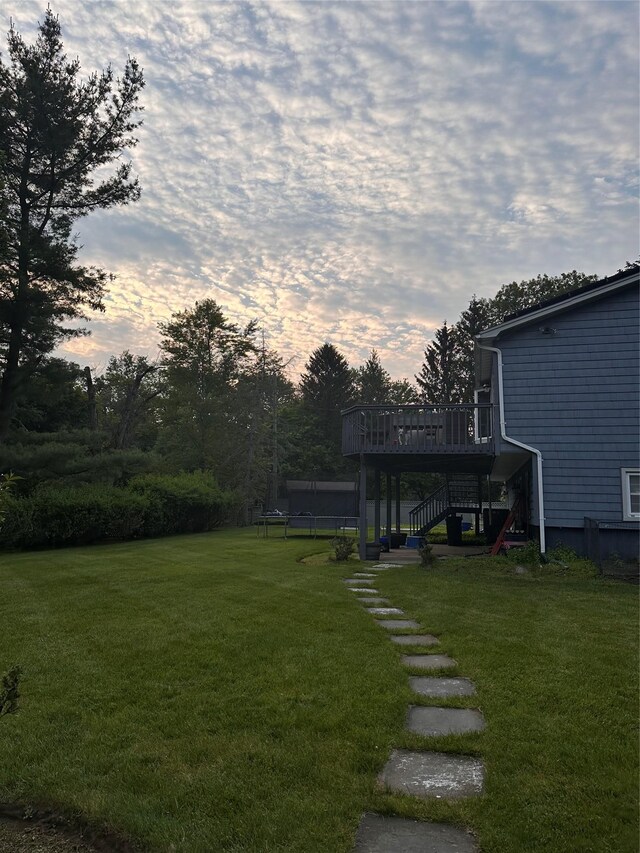 43 N Lorna Ln, Airmont, NY 10901 - view of grassy yard featuring a trampoline, stairs, and a deck