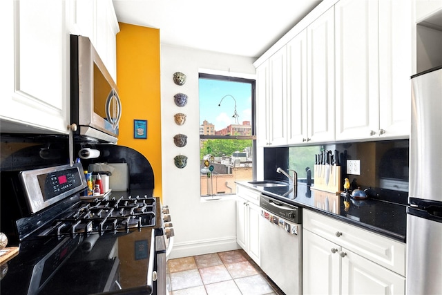 690 Riverside Dr Unit 5E, New York Manhattan, NY 10031 - kitchen with appliances with stainless steel finishes, a sink, baseboards, and white cabinetry