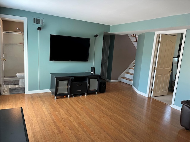 70 Pacific St, North Babylon, NY 11703 - living area featuring stairway and light wood finished floors