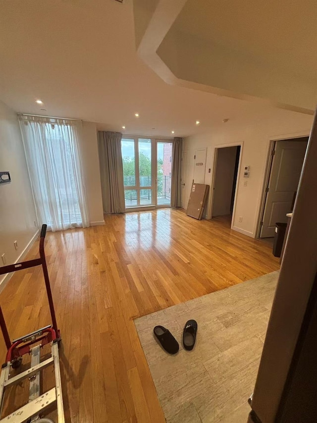4223 Parsons Blvd Unit 5D, Flushing, NY 11355 - unfurnished living room with light wood-type flooring, baseboards, and recessed lighting