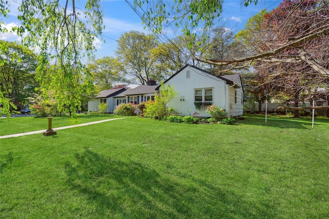 24 Pine St, Lake Grove, NY 11755 - single story home featuring a front yard and a chimney