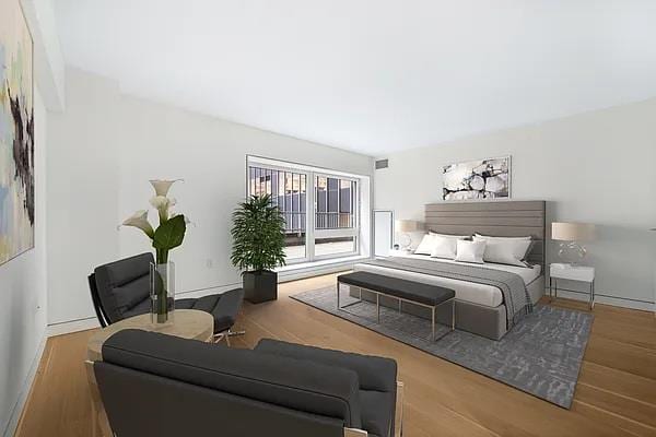 135 W 52nd St Unit 8D, New York Manhattan, NY 10019 - bedroom featuring wood finished floors and baseboards