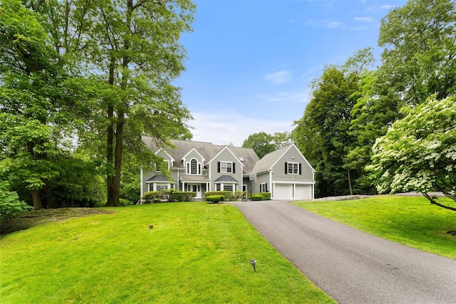 19 Rock Hill Ln, Scarsdale, NY 10583 - view of front of property featuring a garage, driveway, and a front yard