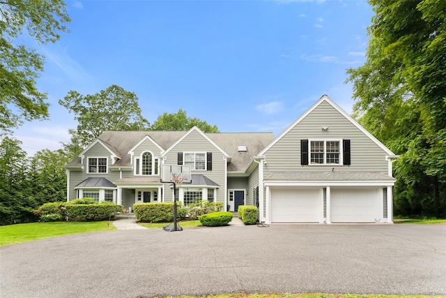 19 Rock Hill Ln, Scarsdale, NY 10583 - view of front facade featuring an attached garage, asphalt driveway, a porch, and roof with shingles