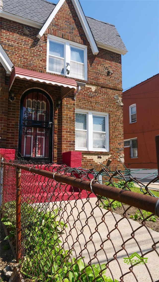 204-03 Murdock Ave, Saint Albans, NY 11412 - doorway to property with brick siding and roof with shingles